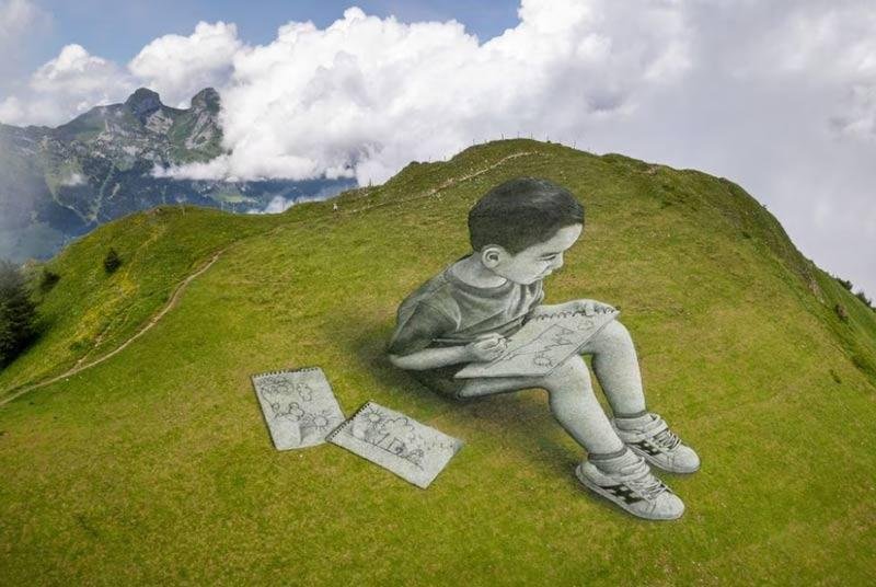 A land art painting representing a child drawing by Swiss-French artist SAYPE is pictured at the Chamossiare in Villars-sur-Ollon, Switzerland