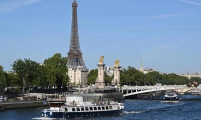 Boats parade past the Eiffel Tower in a rehearsal of the Paris Olympics opening ceremony on the river Seine