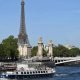 Boats parade past the Eiffel Tower in a rehearsal of the Paris Olympics opening ceremony on the river Seine