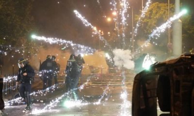 Fireworks explode close to French riot police during protests in Nanterre, west of Paris, on June 28, 2023