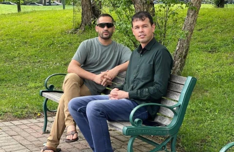 Former US military interpreter Nasrat Ahmad Yar, right, sits with his friend Rahim Amini in Virginia [Courtesy of Rahim Amini]