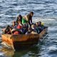 Migrants in a makeshift boat after being found heading for Italy by Tunisian authorities about 50 miles off the coast of Tunisia's city of Sfax