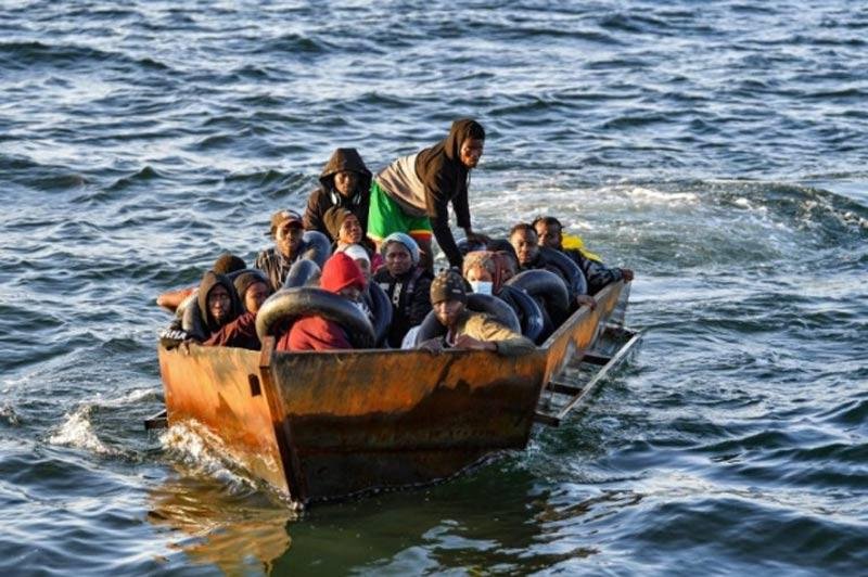 Migrants in a makeshift boat after being found heading for Italy by Tunisian authorities about 50 miles off the coast of Tunisia's city of Sfax