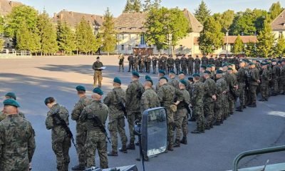 Polish army troops stand guard, as part of the 12th and 17th Mechanized Brigades are starting to move to the east of the country, in Poland