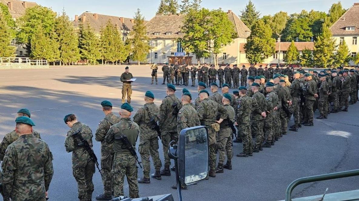 Polish army troops stand guard, as part of the 12th and 17th Mechanized Brigades are starting to move to the east of the country, in Poland