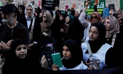 Protesters hold copies of the Koran as they demonstrate outside the Consulate General of Sweden in Istanbul