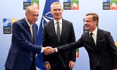 Turkish President Recep Tayyip Erdogan and Swedish Prime Minister Ulf Kristersson shake hands with Nato chief Jens Stoltenberg looking on