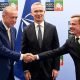 Turkish President Recep Tayyip Erdogan and Swedish Prime Minister Ulf Kristersson shake hands with Nato chief Jens Stoltenberg looking on