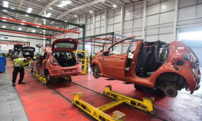 Workers at the vehicle dismantler company Charles Trent Ltd take apart a wrecked vehicle for materials and parts to reuse or recycle