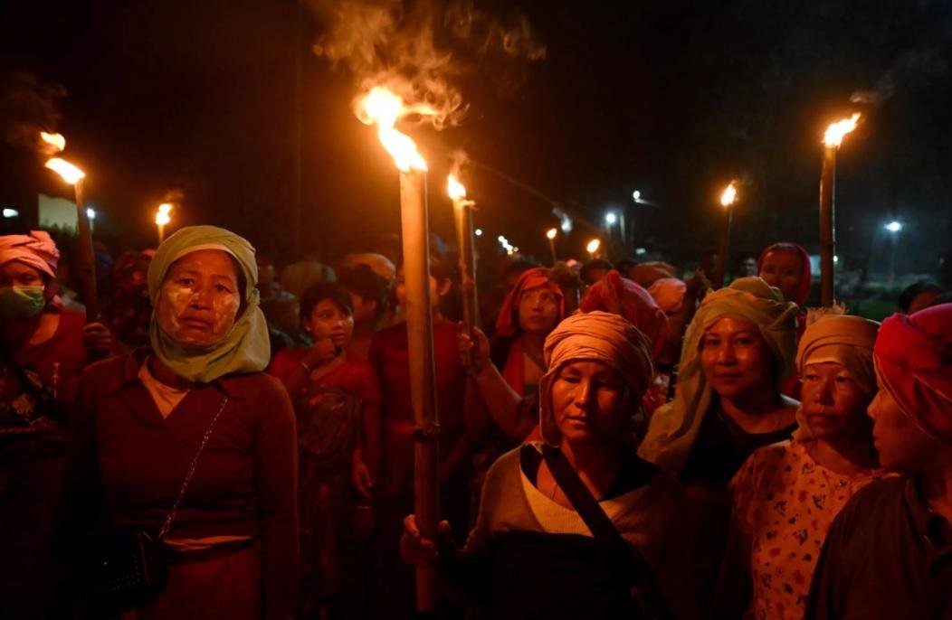 Women from the Meira Paibis group of the Meitei community in India's Manipur state protest against men accused of abusing two Kuki women after a video of the incident emerged