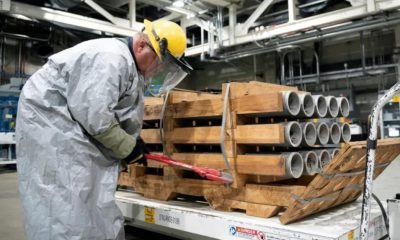 operator cuts the metal bands on a pallet of M55 rockets containing GB nerve agent