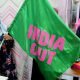 A Progressive Party of Maldives worker poses with an "India Out" flag in Male, Maldives