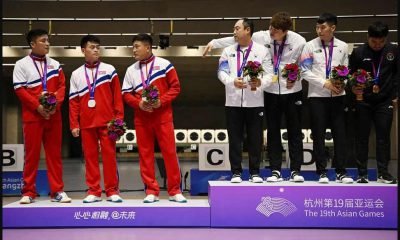 Asian Games - Hangzhou 2022 - Shooting - Fuyang Yinhu Sports Centre, Hangzhou, China - September 25, 2023 Gold medallists South Korea's Ha Kwang-chul, Jeong You-jin and Your Bin Kwak stand on the podium after the Men's Team 10m Running Target Mixed event alongside silver medallists North Korea's Kwon Kwang-il, Pak Myong-won and Songjun Yu