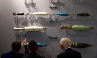 Visitors look at ammunition on display at the Defence and Security Equipment International trade show in London, Britain