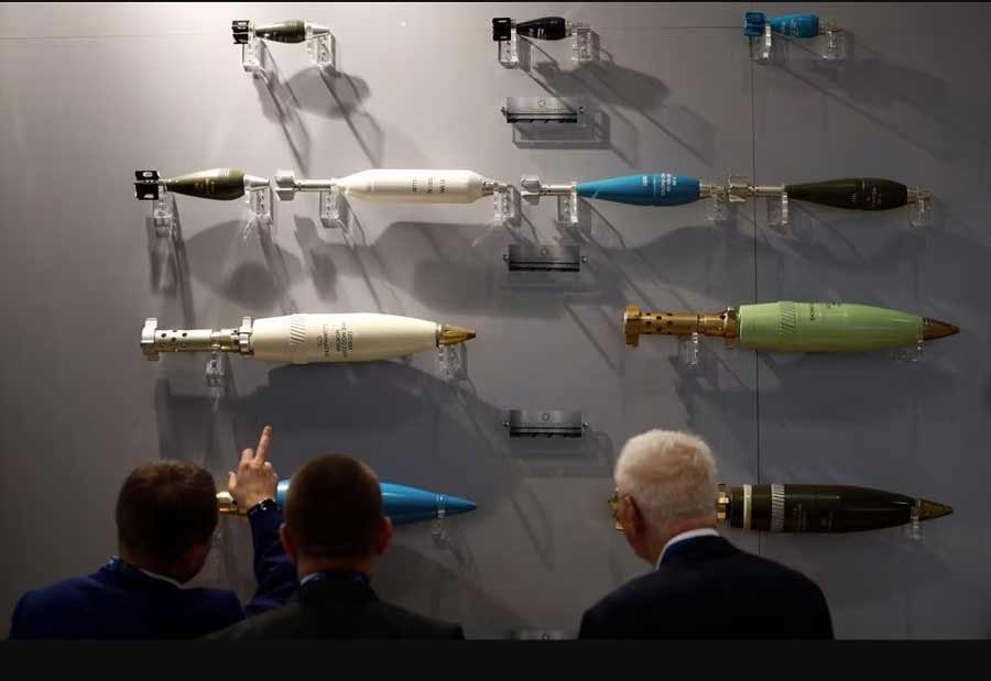 Visitors look at ammunition on display at the Defence and Security Equipment International trade show in London, Britain