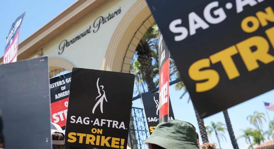 Members and supporters of SAG-AFTRA and WGA walk the picket line at Paramount Studios