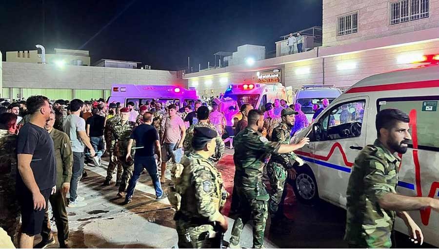 Soldiers and emergency responders carry wounded people after a fire at an event hall, outside the Hamdaniyah general hospital in Al-Hamdaniyah, Iraq on September 27, 2023