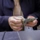 A man counts U.S. dollars at a currency exchange shop in Baghdad,