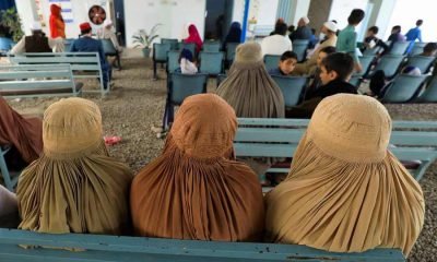 Afghan women who are living in Pakistan wait to get registered during a proof of registration drive at United Nations High Commissioner for Refugees