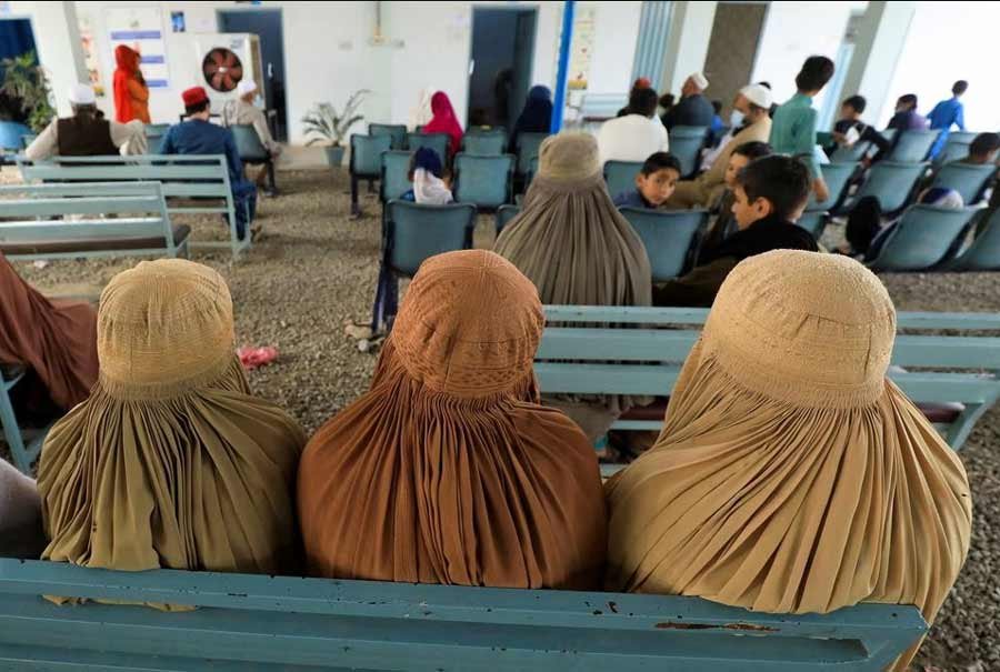 Afghan women who are living in Pakistan wait to get registered during a proof of registration drive at United Nations High Commissioner for Refugees