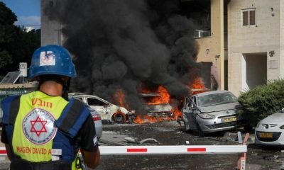 Cars burn after a rocket fired from the Gaza Strip hit a car park and a residential building in Ashkelon, southern Israel