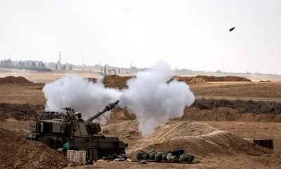 An Israeli tank fires near Israel's border with the Gaza Strip, in southern Israel, October 12, 2023