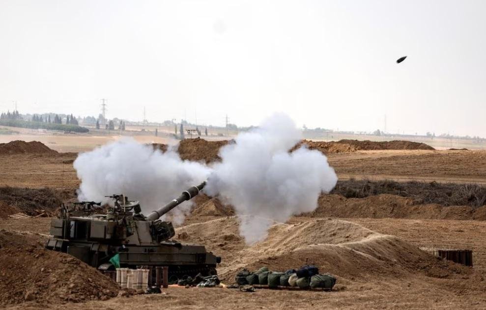 An Israeli tank fires near Israel's border with the Gaza Strip, in southern Israel, October 12, 2023