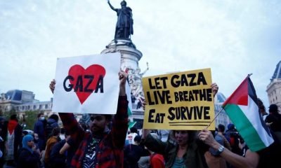 Protestors hold Palestinian flags and placards during an demonstration in support of Palestinians, as part of the ongoing conflict between Israel and the Palestinian Islamist group Hamas, at Place de la Republique in Paris