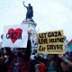 Protestors hold Palestinian flags and placards during an demonstration in support of Palestinians, as part of the ongoing conflict between Israel and the Palestinian Islamist group Hamas, at Place de la Republique in Paris