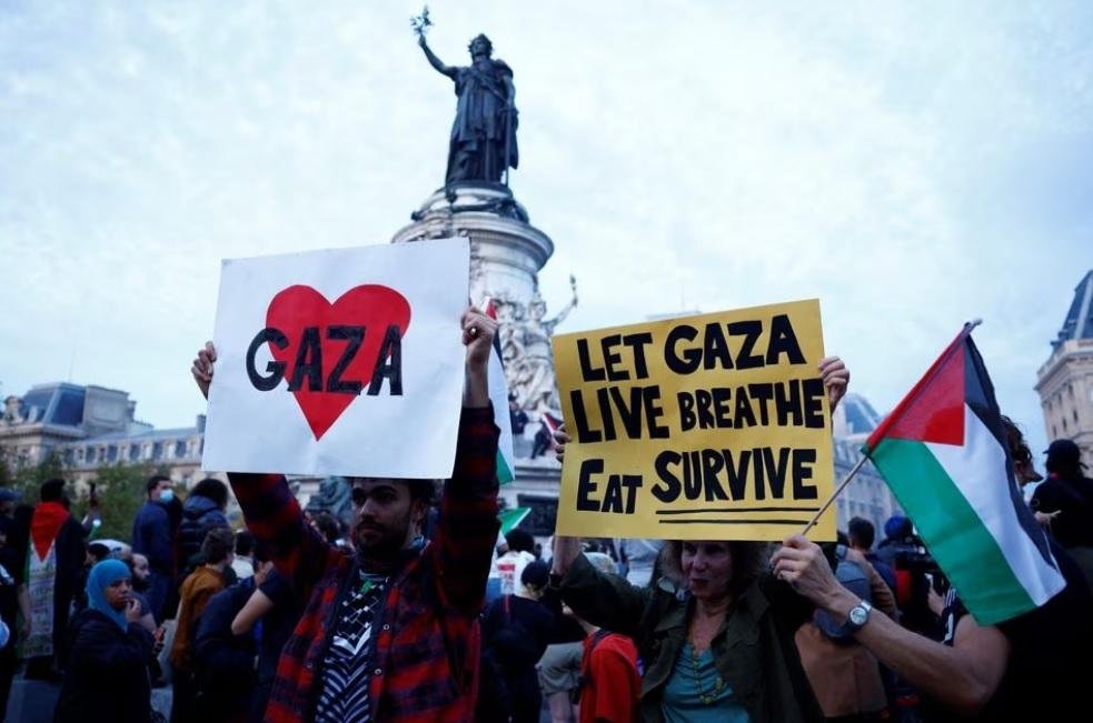 Protestors hold Palestinian flags and placards during an demonstration in support of Palestinians, as part of the ongoing conflict between Israel and the Palestinian Islamist group Hamas, at Place de la Republique in Paris