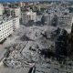 Palestinians gather around residential buildings destroyed in Israeli strikes in Zahra City, amid the ongoing conflict between Israel and Palestinian Islamist group Hamas, in southern Gaza City, October 19, 2023