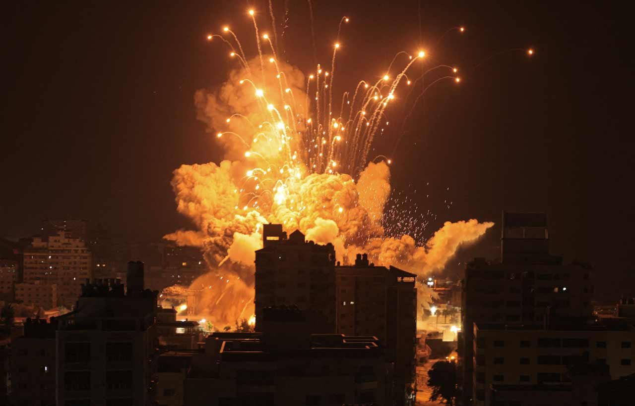 missile explodes in Gaza City during an Israeli air strike on Sunday