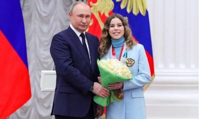 Russian President Vladimir Putin poses for a picture with figure skater and gold medallist of the 2022 Beijing Olympics Anastasia Mishina during an awarding ceremony at the Kremlin in Moscow,