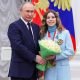 Russian President Vladimir Putin poses for a picture with figure skater and gold medallist of the 2022 Beijing Olympics Anastasia Mishina during an awarding ceremony at the Kremlin in Moscow,