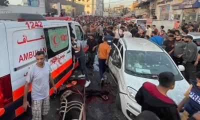 Palestinians check the damages after a convoy of ambulances was hit, at the entrance of Shifa hospital in Gaza City, November 3, 2023.