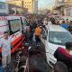 Palestinians check the damages after a convoy of ambulances was hit, at the entrance of Shifa hospital in Gaza City, November 3, 2023.