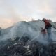 Palestinians conduct search and rescue operations at the site of Israeli strikes on a residential building