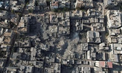 Palestinians gather at the site of Israeli strikes on houses in Bureij in the central Gaza Strip