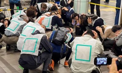 Drill participants cover their heads in a designated area inside Nerima train station in Tokyo, Japan November 6, 2023